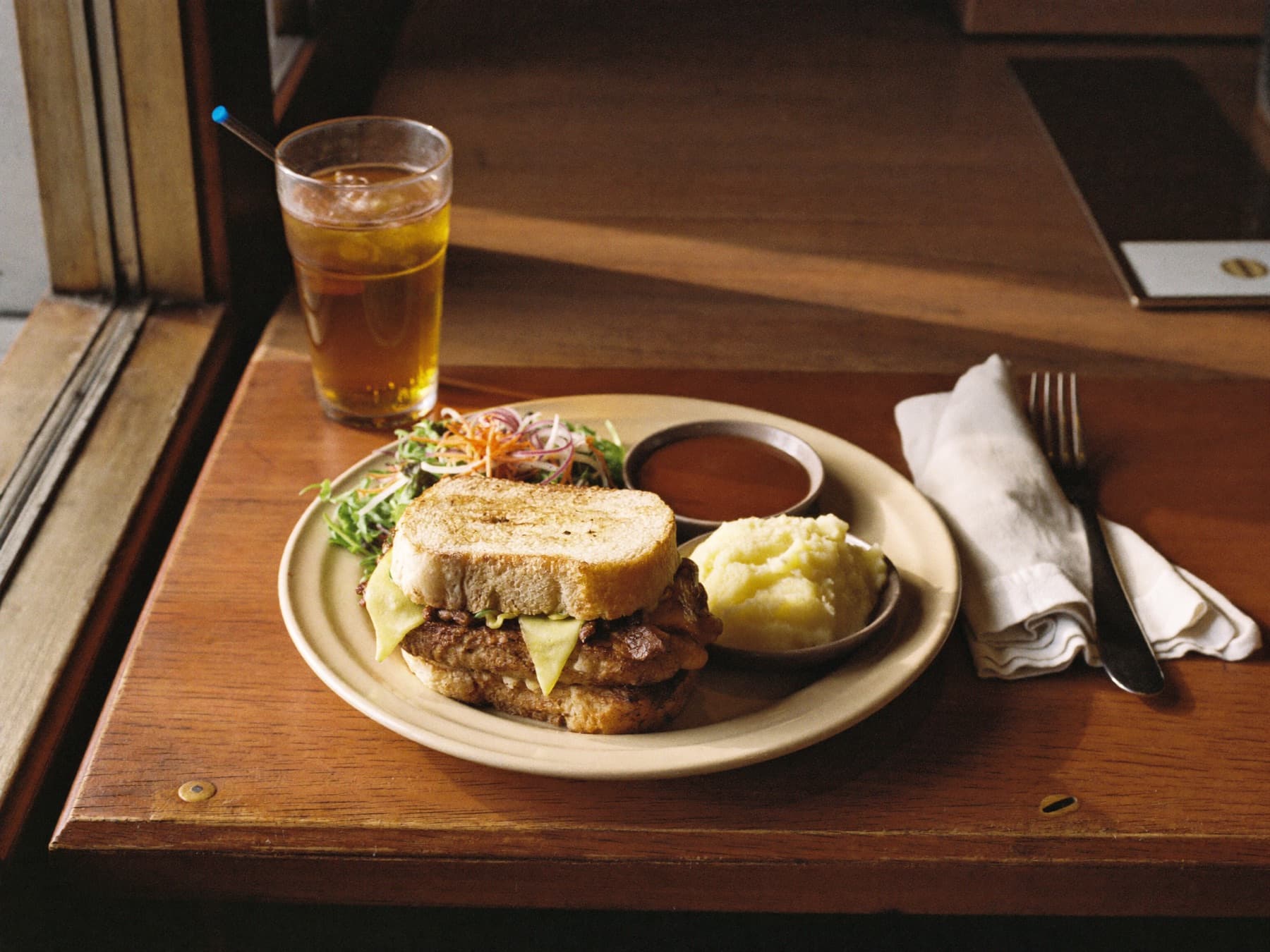 A hot plate lunch waiting on a diner counter